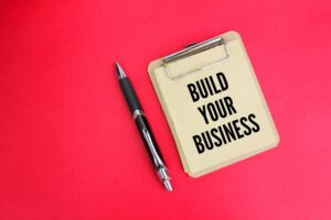 pen and blackboard with the words Build your business